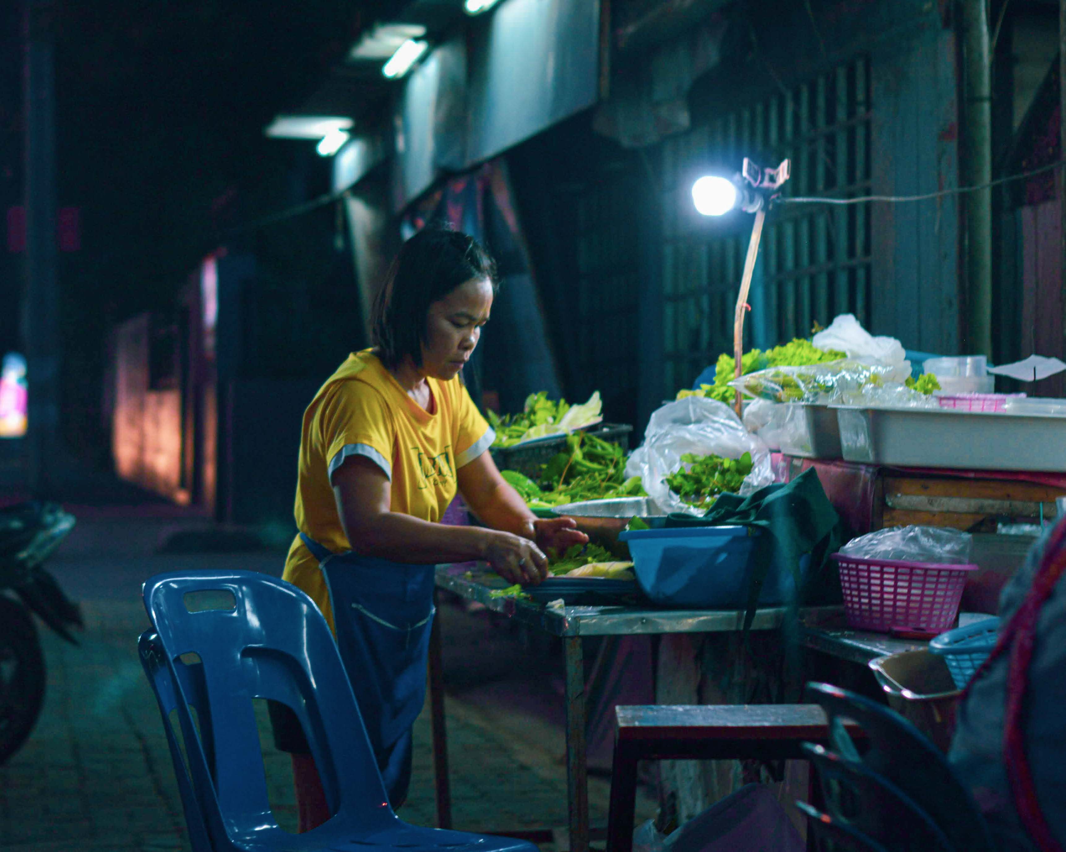Thai street market seller utilizes vegetables